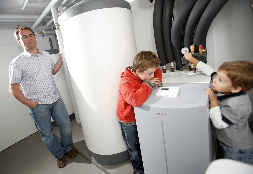 man watching his kids observe How Commercial Water Heaters Work